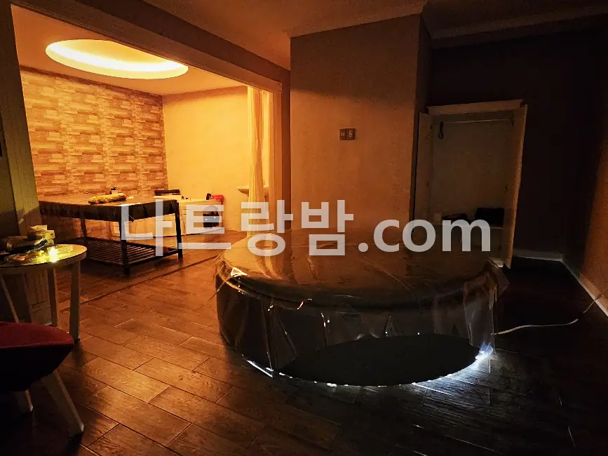 원형 물침대 너머로 관리 테이블이 놓인 체리스파의 넓은 룸