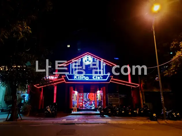 파란 네온 지붕 간판을 올린 키쇼 클럽의 밤 외관